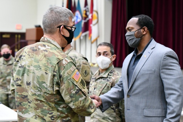 Lt. Gen. James Rainey presents a coin to Mr. Chris Fowler, Executive Officer, Office of the Deputy to the Commanding General.