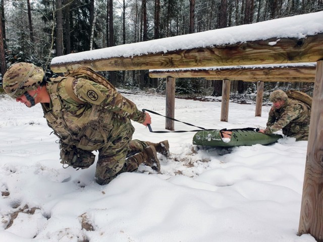 Sgt. Michael Metcalf and Spc. Walter Galdamez train for the 2021 Command Sgt. Maj. Jack L. Clark Jr. U.S. Army Best Medic Competition by evacuating a simulated injured Soldier. (U.S. Army photo by Sgt. Nicole Price)
