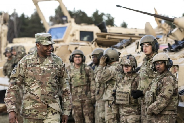 Command Sgt. Maj. Jabari Williams(Right), the senior enlisted advisor of the 2nd Armored Brigade Combat Team, 3rd Infantry Division, checks on the morale of the troops of the brigade during a troop engagement event on Bucierz Range at Drawsko Pomorskie Training Area, Poland, in support of DEFENDER-Europe 20, March 11, 2020. (U.S. Army photo by Staff Sgt. Brian K. Ragin Jr.)