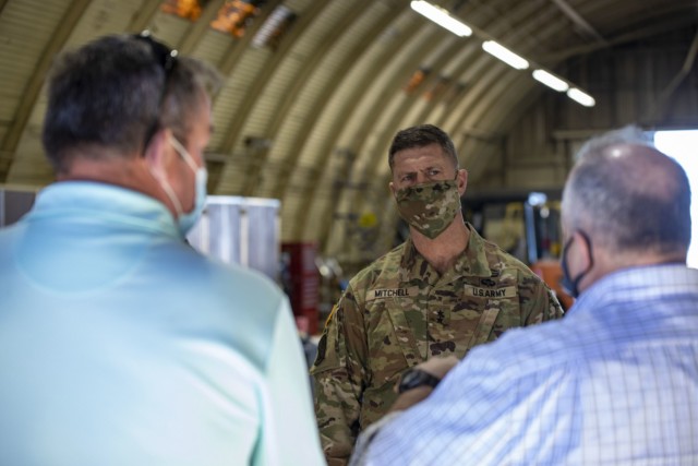 Army Sustainment Command's commanding general Maj. Gen. Daniel Mitchell listens to 402nd AFSB's deputy to the commander Joe Schulz and ASC's director of support operations Dan Reilly explain the challenges feeding Soldiers at remote training...