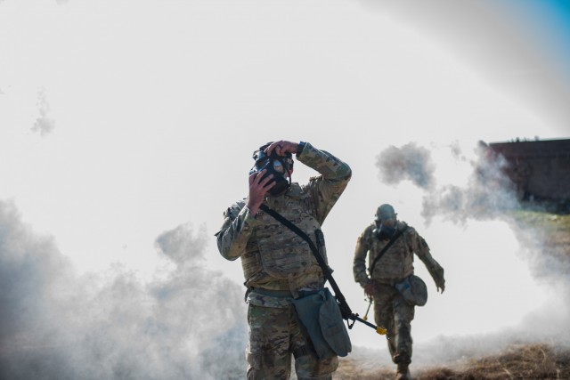 Sgt. Tyler Bisio from 61st Multifunctional Medical Battalion, dons his protective mask after encountering a CBRN threat.  During the Soldier and Noncommissioned Officer of the Year and Best Medic competitions, Soldiers took on challenging tasks testing their basic Soldier and medic skills. (U.S. Army photo by Sgt. 1st Class Kelvin Ringold)