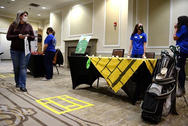 Sara Dunn peruses informational booths as Christi King, Fort Leavenworth Spouses’ Club first vice president, and Katie Payne, FLSC newsletter chairperson, stand ready to share information about the upcoming charity golf scramble during the FLSC...