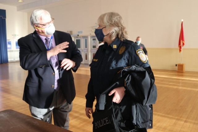 From left, Chief of Preventative Medicine and Public Health Emergency Officer Dr. W. Thomas Frank, from Kirk U.S. Army Health Clinic, answers a question about the COVID-19 vaccine raised by Capt. Dawn Fischer during a vaccination clinic held in the APG North (Aberdeen) recreation center Jan. 7. 