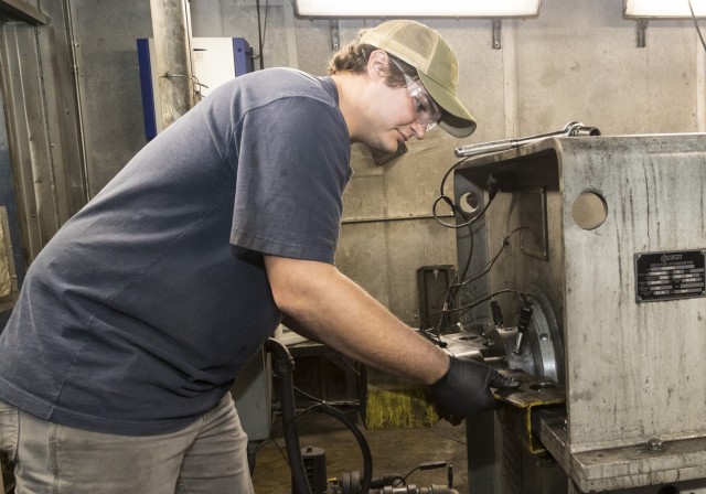 Caleb Vice, an Anniston Army Depot mechanic, makes repairs to an engine dynamometer.