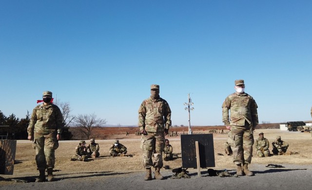 Basic Combat trainees stand ready to walk down their rifle marksmanship lane and see if they zeroed their weapons Jan. 14, 2021, at Fort Sill, Oklahoma. About 3,000 trainees who left for holiday block leave were tested for COVID-19 on their return...