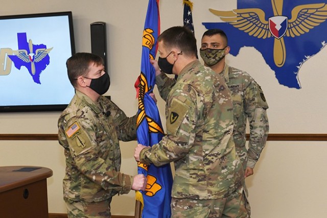 Sgt. Maj. William M. Peden (left) accepts the Corpus Christi Army Depot flag from (middle) CCAD commander Col. Joseph H. Parker and assumes responsibility for the depot in a virtual assumption-of-responsibility ceremony Jan. 5 as (right) Sgt....