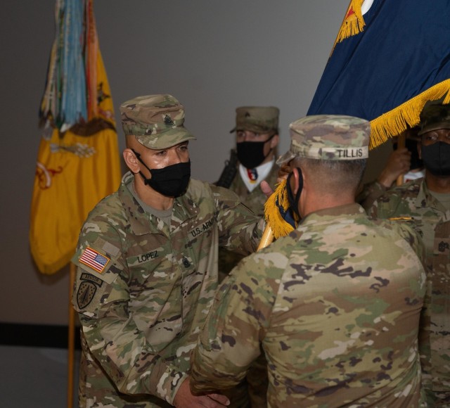 Col. Terry R. Tillis, the commander of 2nd Armored Brigade Combat Team, 3rd Infantry Division, passes
the brigade colors to incoming senior enlisted advisor Command Sgt. Maj. Jaime Lopez during a change
of responsibility ceremony, Jan. 22, 2021, at Woodruff Theater on Fort Stewart, Georgia. The ceremony
marks the official transition of responsibility from Command Sgt. Maj. Jabori O. Williams to Command Sgt.
Maj. Lopez.
(U.S. Army photo by Spc. Devron Bost)