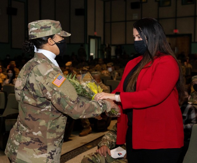 Kory Lopez, wife of incoming senior enlisted advisor, Command Sgt. Maj. Jaime Lopez receives yellow
roses to welcome her into the Spartan Brigade family during a 2nd Armored Brigade Combat Team, 3rd
Infantry Division, change of responsibility ceremony, Jan. 22, 2021, at Woodruff Theater on Fort Stewart,
Georgia.
(U.S. Army photo by Spc. Devron Bost)