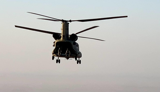 A CH-47 Chinook helicopter, operated by Soldiers with Bravo Company, 3-238th General Support Aviation Battalion, 28th Expeditionary Combat Aviation Brigade, flies over the 28th ECAB's area of operations in the Middle East during a routine...