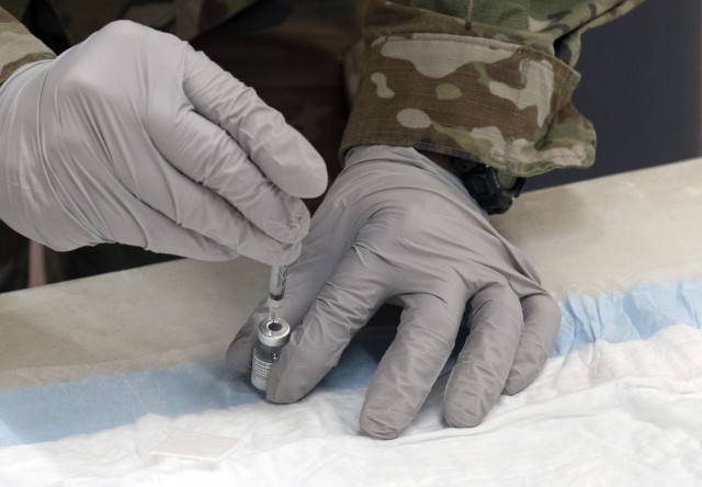 Sgt. Wayne Parnell, a healthcare specialist at Moncrief Army Health Clinic, fills a syringe with COVID-19 vaccine Jan. 8 at the Solomon Center on Fort Jackson.