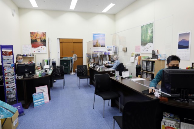 From left, Yuko Inoue, operations officer for Zama ITT; Lawrence Clements, Zama ITT liaison officer; and Katsuhisa Takagi, sales representative for Zama ITT, works at their desks in the Zama ITT office, Camp Zama, Japan, Jan. 22. The office is...