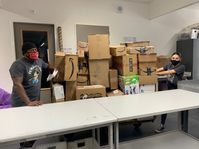 BRUNSSUM, Netherlands -- Members of the postal service team at the Brunssum Site of U.S. Army Garrison Benelux move a load of packages Nov. 20, 2020. Although postal operations did not need volunteers specifically at the community mail room in...