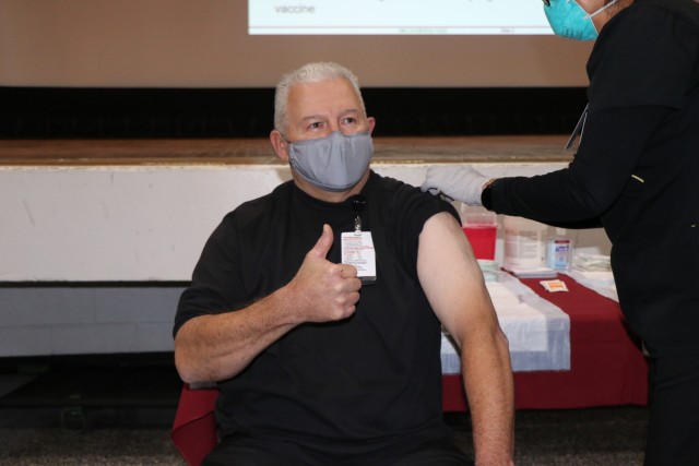 James Baker, a healthcare information technology specialist with William Beaumont Army Medical Center receive the Pfizer vaccine.