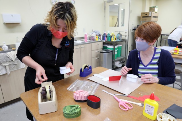 Saori Komura, left, an art instructor for the Camp Zama Arts and Crafts Center, helps Suzanne Ohsiek make a washi paper box at Camp Zama, Japan, Jan. 23.