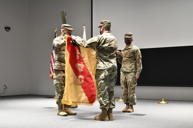 Col. Duane Burk, 647th Regional Support Group commander, and Command Sgt. Thomas Brehmer, 647th Regional Support Group command sergeant major, uncase the brigade colors during a socially distanced transfer of authority ceremony at Sage Hall, Fort Bliss, Texas, Jan. 25, 2021. The 647th Regional Support Group assumed the Fort Bliss Mobilization Brigade mission from the 648th Regional Support Group. (U.S. Army photo by Capt. Brandon D. Fambro)
