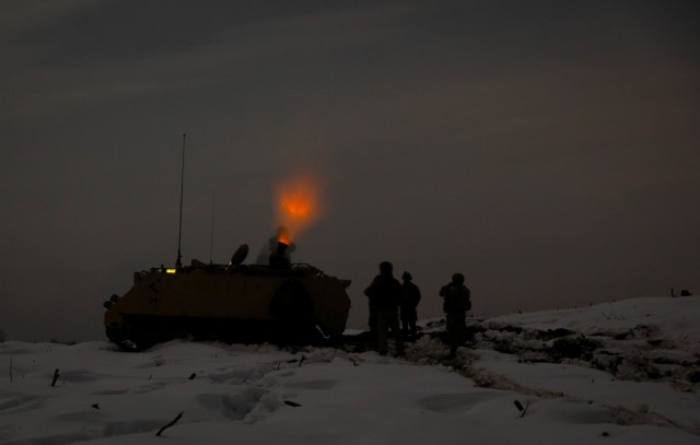 Lithuanian and U.S. mortarmen fire mortars at night Jan. 23, 2021, at the Pabrade Training Area, Lithuania. The combined training event offered Lithuanian Griffin Brigade’s 23rd Battalion hands-on experience with 2nd Battalion, 8th (U.S.) Cavalry Regiment’s mortar weapon platform, increasing battlefield lethality. (U.S. Army photo by Sgt. Alexandra Shea)