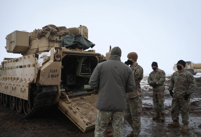 U.S. Army 1st Lt. Michael Elliot, right, Charlie “Cobra” Company, 2nd Battalion, 8th (U.S.) Cavalry Regiment fire support officer, explains the capabilities of the Bradley Fire Support Vehicle to a Lithuanian platoon commander assigned to Griffin Brigade’s 23rd Battalion during a combined mortar training mission Jan. 23, 2021, at the Pabrade Training Area, Lithuania. (U.S. Army photo by Sgt. Alexandra Shea)