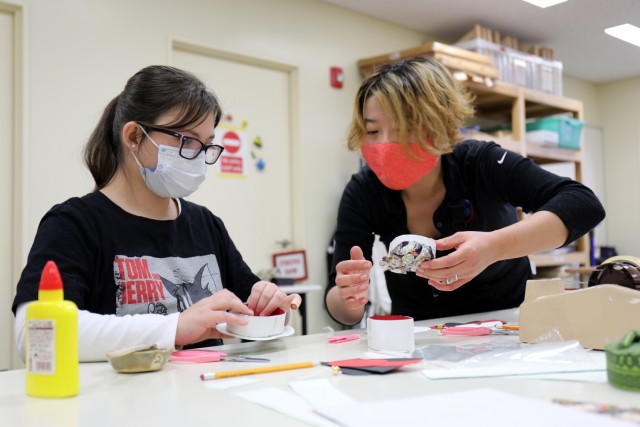 Saori Komura, right, an art instructor for the Camp Zama Arts and Crafts Center, helps Camryn Rosa, 11, make a washi paper box at Camp Zama, Japan, Jan. 23.
