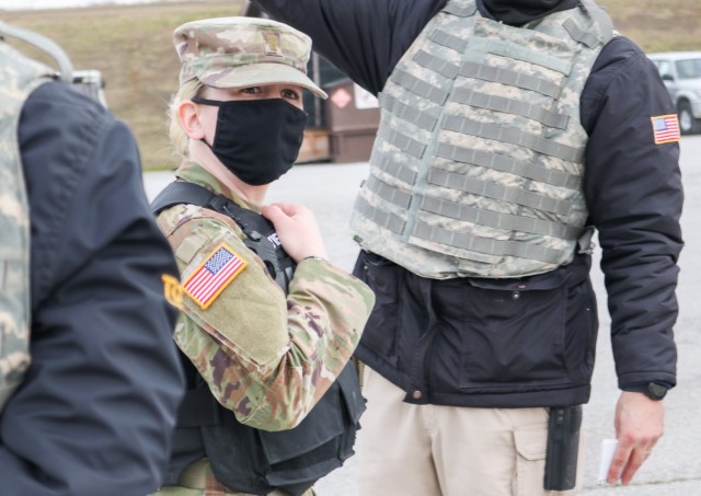 2nd Lt. Allison Vierps, military police officer in charge of Regional Command-East, Kosovo Force 28, coordinates with security contractors during a joint force protection exercise at Camp Bondsteel, Kosovo, on Jan. 23, 2021. A mock vehicle-borne...