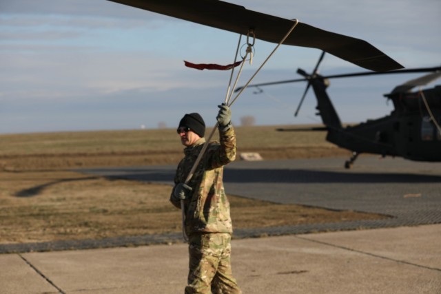 MIHAIL KOGALNICEANU, Romania – Lt. Col. Jesse Blanton, Commander, 5th Battalion, 101st Aviation Regiment helps to secure a UH-60 after returning to base from an air assault training with Romanian allies Jan. 20. Working together during the...