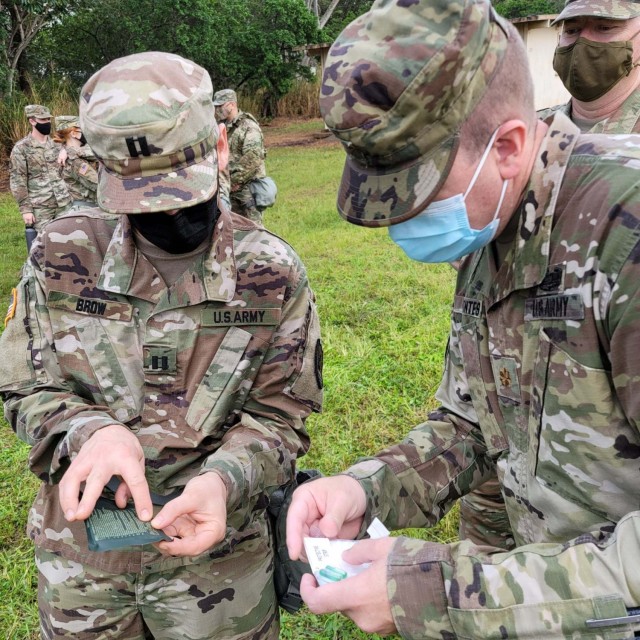 Multi-component Soldiers assigned to the 311th Signal Command (Theater), demonstrate skin decontamination procedures in a simulated Chemical, Biological, Radiological, Nuclear, and Explosive environment during a Battle Assembly, Jan. 23-24, 2021, to train Soldiers on Army Warrior Tasks at Schofield Barracks on Oahu, Hawaii (Official U.S. Army photo by Warrant Officer Alyson Tugaoen).