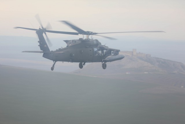 MIHAIL KOGALNICEANU, Romania – A UH-60 from Bravo Co., 5th Battalion, 101st Aviation Regiment flies over a castle while returning to base from an air assault training with Romanian allies Jan. 20.Working together during the planning and...