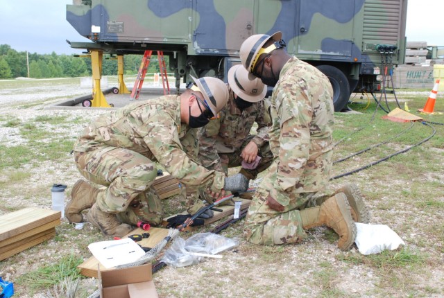 Students from the U.S. Army Prime Power School repair a spliced electrical cable during one of many electrical outage scenarios incorporated in the Prime Power Capstone Training Exercise at the Contingency Basing Integration Training and...