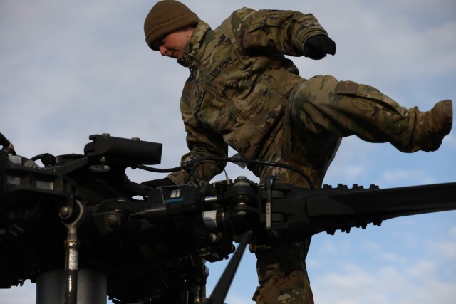 MIHAIL KOGALNICEANU, Romania – Sgt. Petra Machuca, UH-60 Crew Chief, Bravo Co., 5th Battalion, 101st Aviation Regiment secures the helicopter after returning to base from an air assault training with Romanian allies Jan. 20. Working together...