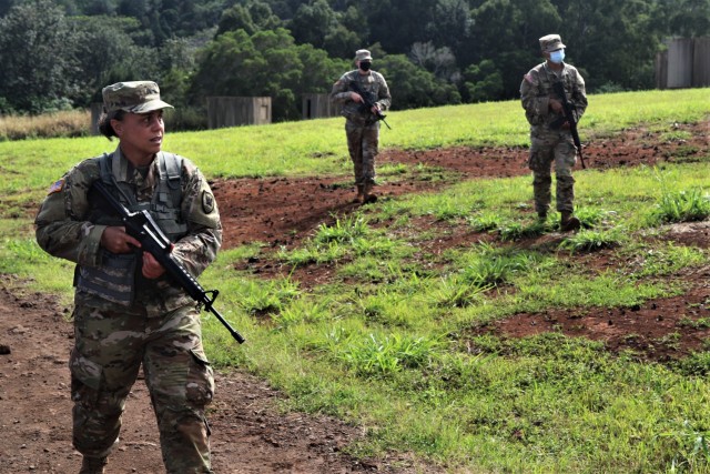 Army Sgt. Kawaiola Nahale (foreground), Headquarters and Headquarters Company, 311th Signal Command (Theater) leads a patrol movement through a Military Operations in Urban Terrain facility during the command's Battle Assembly, Jan. 23-24, 2021 at...