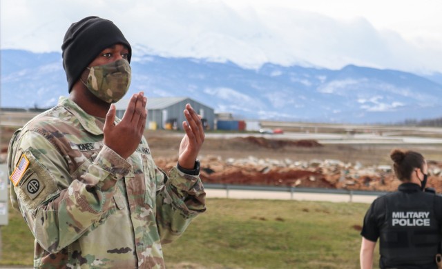 Sgt. Erik Jones, an evacuation platoon sergeant for Regional Command-East, Kosovo Force 28, guides a field ambulance for staging during a joint force protection exercise in Kosovo on Jan. 23, 2021. A mock vehicle-born improvised explosive device...