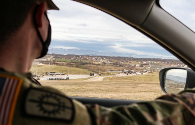 Sgt. 1st Class Michael Raines, provost sergeant for Regional Command-East, Kosovo Force 28, surveys the main gate during a joint force protection exercise at Camp Bondsteel, Kosovo, on Jan. 23, 2021. A mock vehicle-born improvised explosive device...
