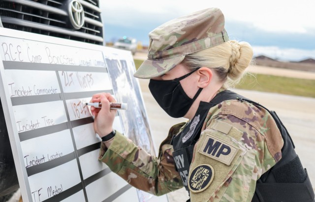 2nd Lt. Allison Vierps, the military police officer in charge of Regional Command-East, Kosovo Force 28, annotates the incident type on a board during a joint force protection exercise at Camp Bondsteel, Kosovo, on Jan. 23, 2021. A mock...
