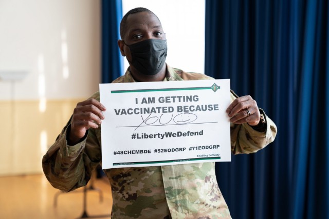 Lt. Col. Anterrio Gainwell, Countering Weapons of Mass Destruction Team chief for the 20th Chemical, Biological, Radiological, Nuclear, Explosives command, displays his motivation for getting the COVID-19 vaccine at the Aberdeen Proving Ground, Maryland, recreation center Jan. 12. Soldiers and civilians identified as critical health care, emergency and public safety personnel stationed at APG received their first of two required COVID-19 vaccine shots as part of Kirk Army Health Clinic’s vaccine rodeo. (U.S. Army Public Health Center photo by Graham Snodgrass)