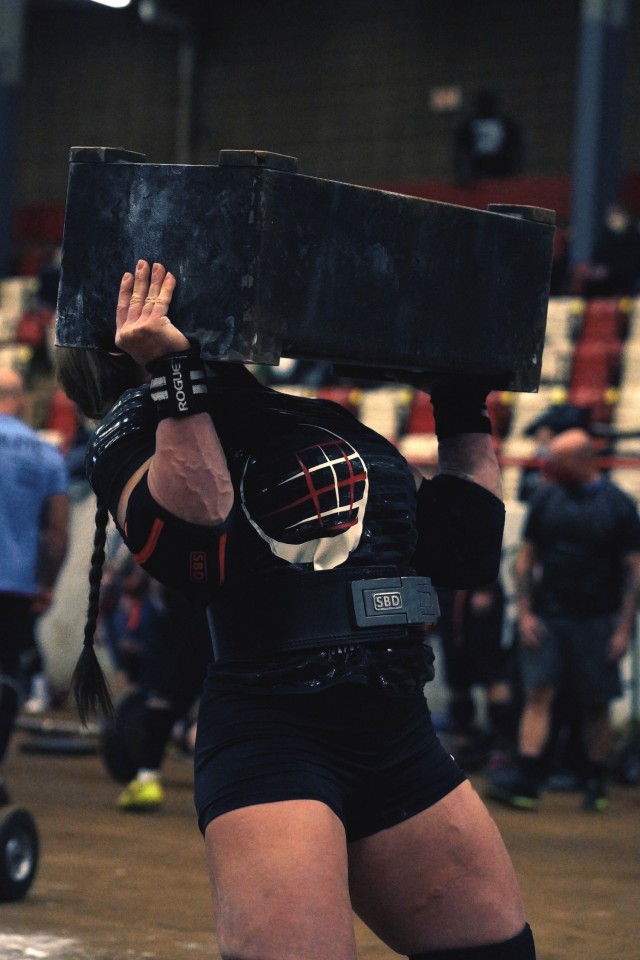 Staff Sgt. Gabriele Burgholzer attempts to lift Mouser block over her head during the Mammoth Strength Challenge on Jan. 23 in Bowling Green, Kentucky.