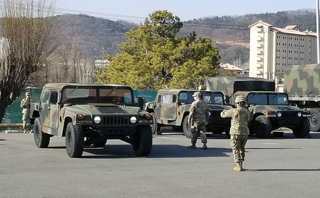 Soldiers with the 563rd Medical Logistics Company conduct proper guiding techniques for backing up a Humvee during the unit's driver's training, held Jan. 11-15 at Camp Carroll, South Korea. (U.S. Army photo by Sgt. 1st Class Rizmel Paguio)