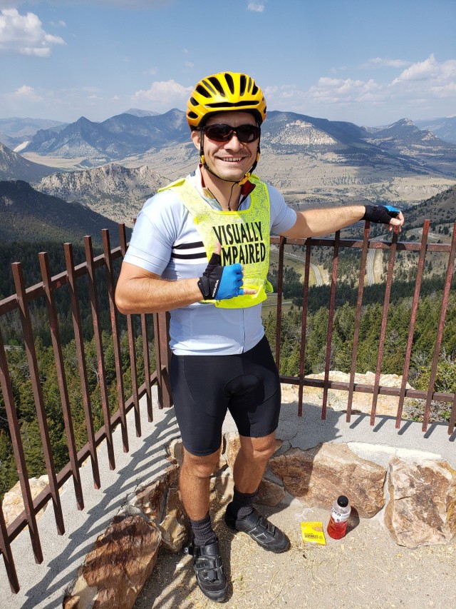 Staff Sgt. Mike Murphy poses in front of the landscape where he rode as part of the Beartooth Challenge. (Photo via Marc Cattapan)