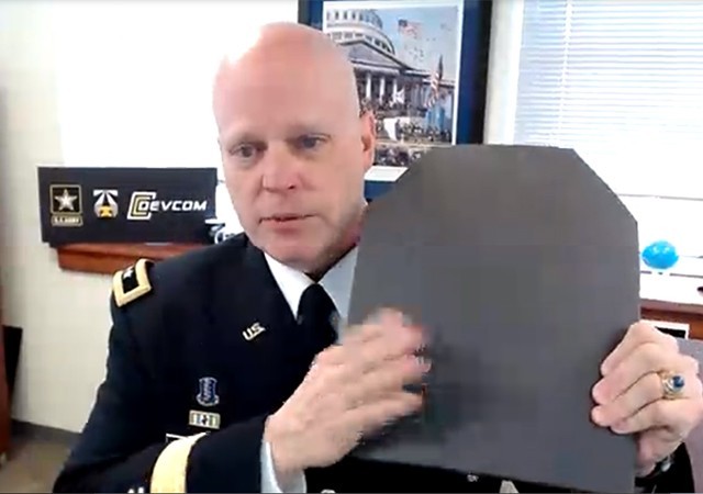 Maj. Gen. John George, commanding general of the Combat Capabilities Development Command, shows off improved body armor made possible by DEVCOM scientist Michael Golt who received the 2020 Major General Greene Individual Innovation Award his innovative techniques to measure ballistic performance to discover superior armor using automation and artificial intelligence. George spoke on behalf of the DEVCOM awardees during the virtual ceremony held Jan. 28, 2021.