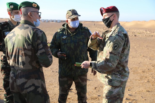 Capt. Jonathan Paul, 173rd Brigade (Airborne), explains his unit's training requirements to Moroccan military planners during a site suvery in Morocco Jan. 22, 2021, for exercise African Lion 21. Scheduled for June, African Lion, U.S. Africa Command's largest exercise, has increased interoperability among U.S. partners and Allies since 2003. Plans for AL21 involve more than 10,000 troops from the United States, Morocco, Tunisia, Senegal and elsewhere. The global COVID-19 pandemic curtailed the previous year's exercise. Plans for AL21 include COVID-19 mitigations and flexible options to ensure maximum participation and value for participating countries. (U.S. Army photo by Maj. Cain S. Claxton/Southern European Task Force, Africa)