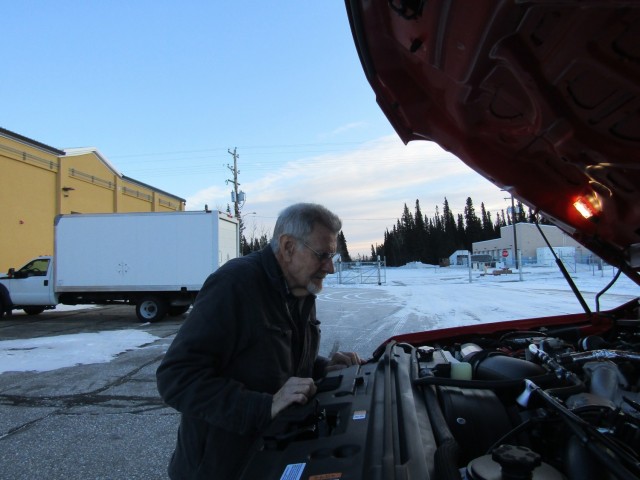 Rob Gibbens checks over a new truck assigned to the fire department at Fort Greely.