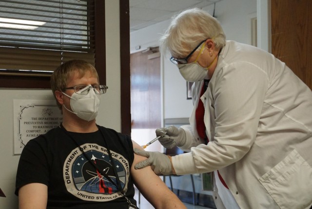 Nurse giving man shot