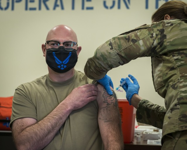 U.S. Air Force Lt. Col. Andy Kelly, 103rd Medical Group commander, receives the Moderna COVID-19 vaccine at Bradley Air National Guard Base in East Granby, Connecticut, Dec. 30, 2020. The Connecticut National Guard began administering the vaccine in accordance with the Department of Defense COVID-19 Vaccine Distribution Plan, with doses voluntarily administered to Soldiers and Airmen on the front lines of the COVID-19 pandemic response. (U.S. Air National Guard photo by Staff Sgt. Steven Tucker)