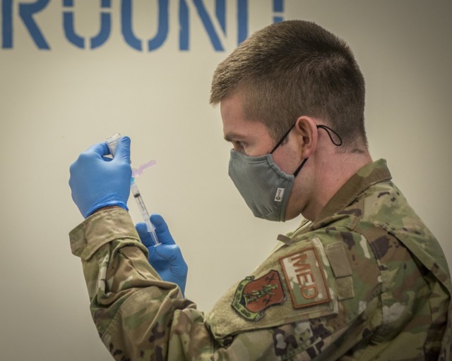 U.S. Air Force Capt. Greg Flis, 103rd Medical Group nurse practitioner, draws Moderna COVID-19 vaccine from a vial into a syringe at Bradley Air National Guard Base in East Granby, Connecticut, Dec. 30, 2020. The Connecticut National Guard began administering the vaccine in accordance with the Department of Defense COVID-19 Vaccine Distribution Plan, with doses voluntarily administered to Soldiers and Airmen on the front lines of the COVID-19 pandemic response. (U.S. Air National Guard photo by Staff Sgt. Steven Tucker)