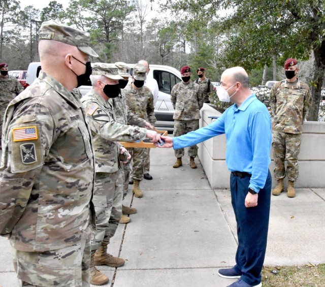 Lt. Gen. Douglas Gabram (left), Commanding General, U.S. Army Installation Management Command, hands coins to Fort Polk IMCOM employees for their exemplary work, Jan. 26.