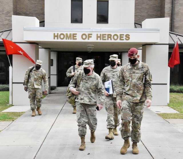 Lt. Gen. Douglas M. Gabram (center), Commanding General, U.S. Army Installation Management Command, exits Woodfill Hall (bldg 350) with Fort Polk leaders on their way to tour housing areas on the installation. 