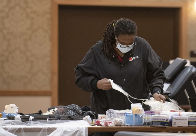 Sarina Mickle, a volunteer with American Red Cross  prepares the necessary equipment moments before the beginning of a Community Blood Drive at the NCO Club  on post Jan. 25.