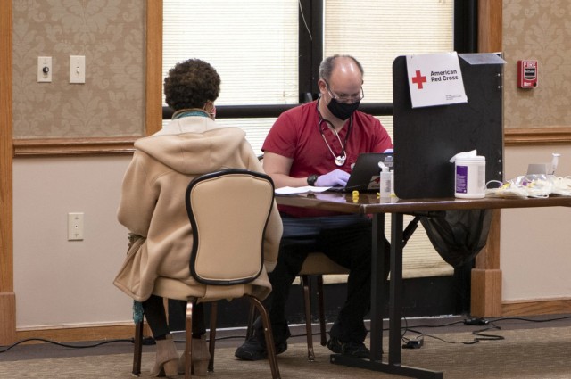 David Beale, a volunteer with American Red Cross takes a donors information during a Community Blood Drive at the NCO Club  on post Jan. 25.