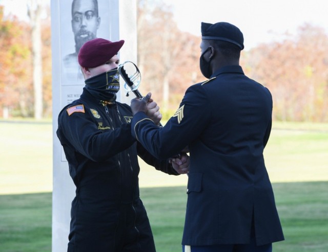 Sgt. Jon Pemberton, left, passes a sabre to Sgt. James Akinola before the National Museum of the U.S. Army&#39;s grand opening ceremony at Fort Belvoir, Va., Nov. 10, 2020. 