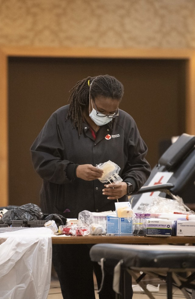 Sarina Mickle, a volunteer with American Red Cross  prepares the necessary equipment moments before the beginning of a Community Blood Drive at the NCO Club  on post Jan. 25.