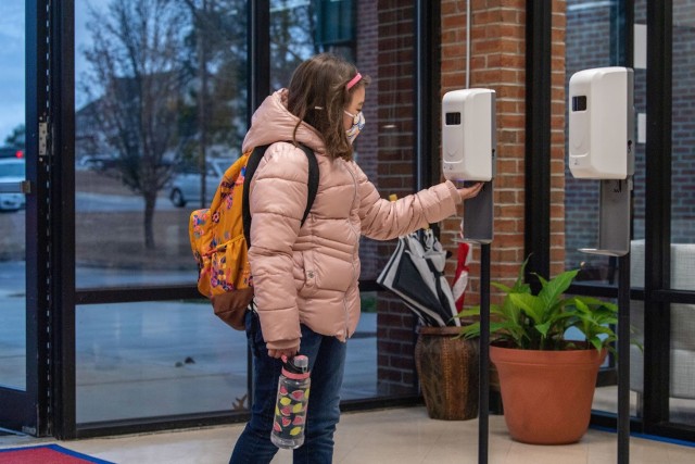 Marilyn Rivera, a 3rd grader with C.C. Pinckney Elementary School, uses hand sanitizeras she enters the school Jan. 25. for the first day of face-to-facxe teaching since March 2020. Fort Jackson schools are following rigorous COVID-19 precautions...