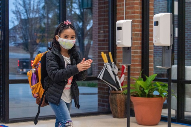 Seivahni Torres, a 3rd grader with C.C. Pinckney Elementary School, uses hand sanitizeras she enters the school Jan. 25. for the first day of face-to-facxe teaching since March 2020. Fort Jackson schools are following rigorous COVID-19 precautions...